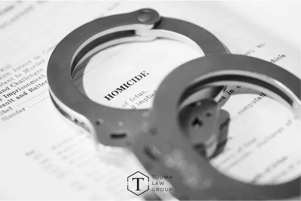 a homicide report and handcuffs on a table
